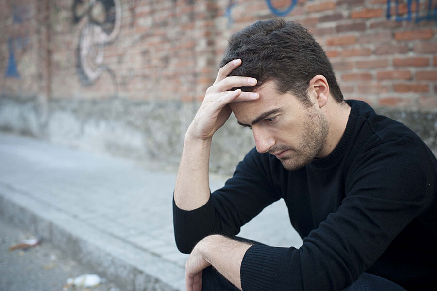 man thinking about needing inpatient drug rehab