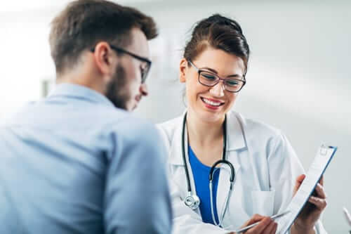 doctor and patient discuss trauma informed care through a trauma informed approach