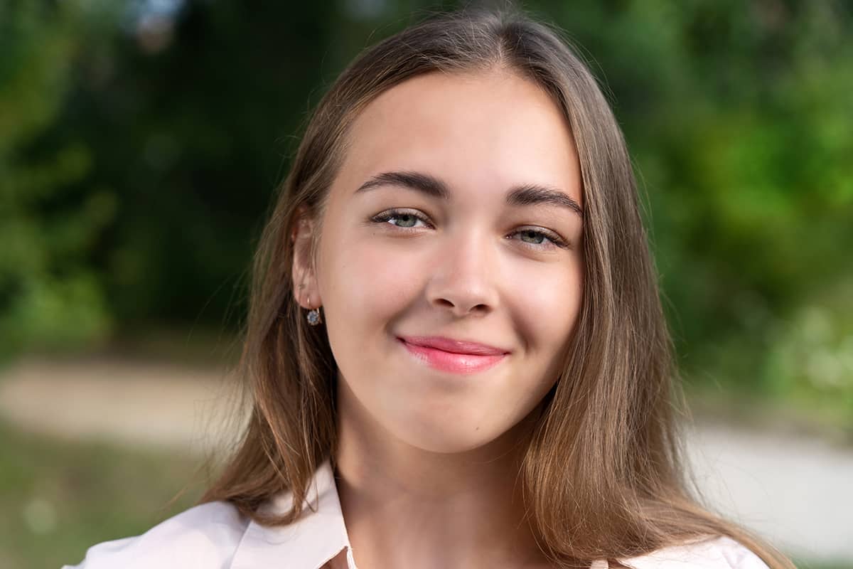 a woman smiles as she thinks about mental health awareness week