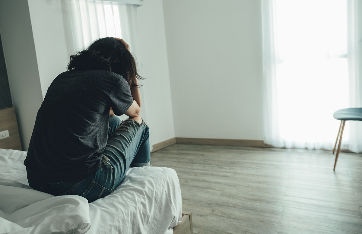 Woman distressed thinking about drug dependence vs drug addiction